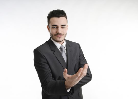isolated young business man with positive attitude convincing with hands
