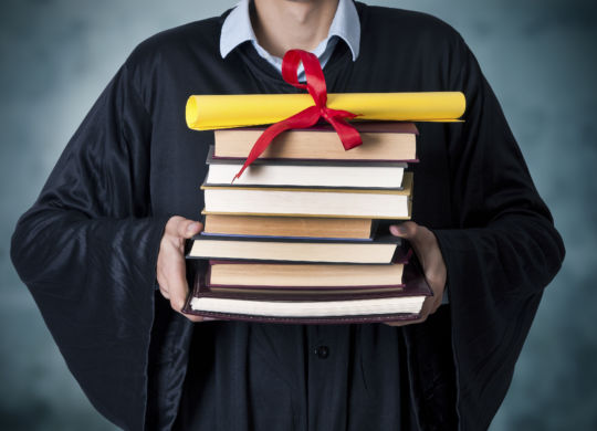 graduate with books and diploma