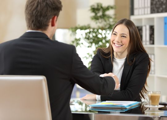 Businesspeople handshaking after negotiation or interview at office